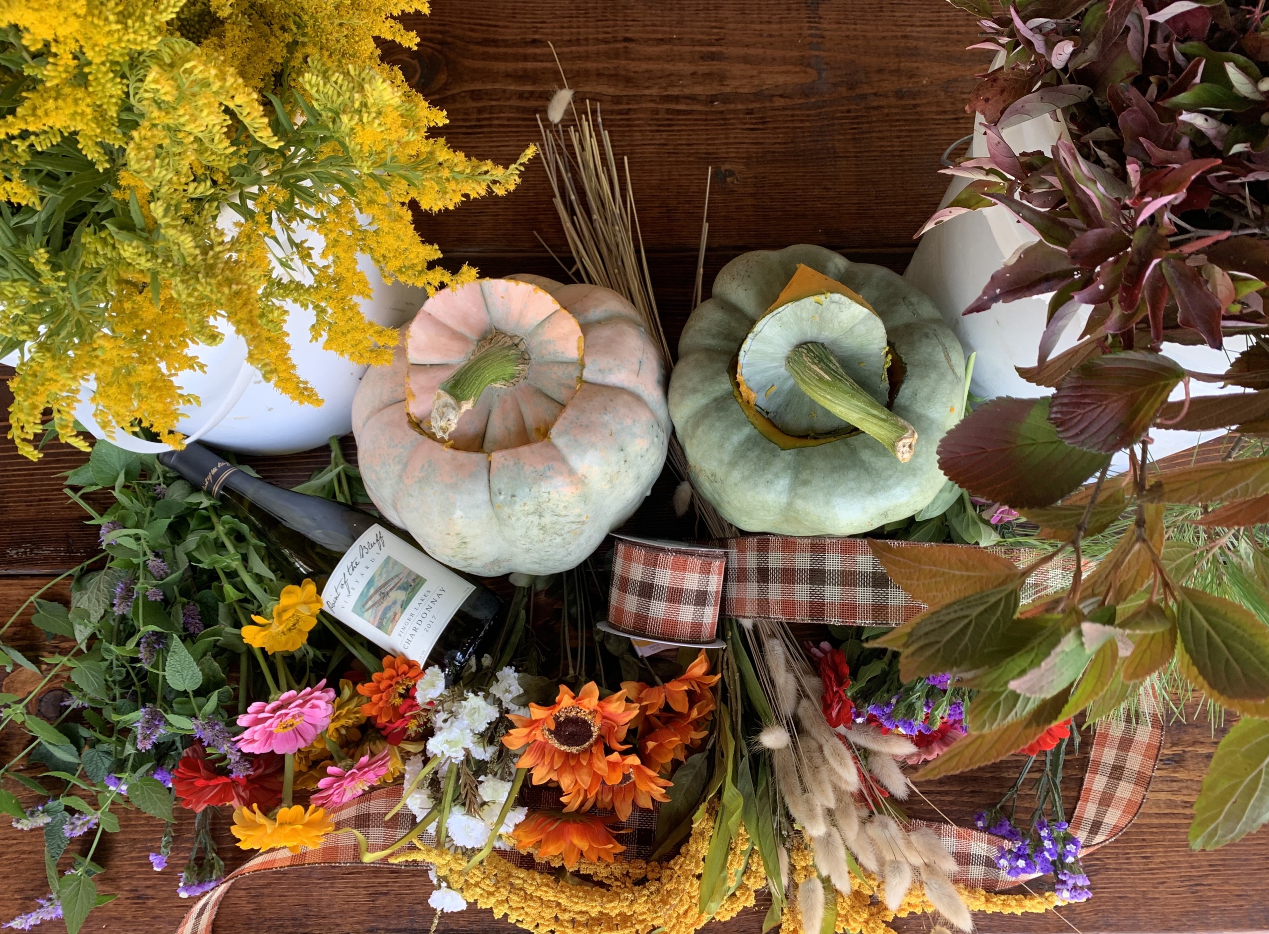 Pumpkins, flowers, and wine displayed for the workshop